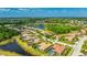 Wide aerial view showcasing community real estate with green spaces, mature trees, and neighborhood waterways at 12822 Kite Dr, Bradenton, FL 34212