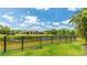 Picturesque backyard with lush greenery, a serene pond, and a secure fence, creating a tranquil outdoor space at 12822 Kite Dr, Bradenton, FL 34212