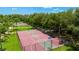 Overhead of a basketball court and tennis court surrounded by trees and landscaping for community enjoyment at 12822 Kite Dr, Bradenton, FL 34212