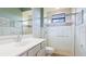 Well-lit bathroom with tiled shower, vanity, and bright mirror at 12822 Kite Dr, Bradenton, FL 34212