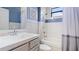 Well-lit bathroom featuring a single sink vanity and a shower-tub combo with stylish blue and white accents at 12822 Kite Dr, Bradenton, FL 34212