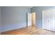Bedroom with wood floors, light-blue walls, a closet, and recessed lighting at 12822 Kite Dr, Bradenton, FL 34212