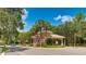 Community entrance with a gatehouse, well-maintained landscaping, and a car approaching at 12822 Kite Dr, Bradenton, FL 34212
