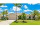 Inviting one-story home with lush landscaping, palm trees, and a two-car garage under a sunny sky at 12822 Kite Dr, Bradenton, FL 34212