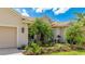 A home's exterior showcasing meticulous landscaping around the driveway and front facade at 12822 Kite Dr, Bradenton, FL 34212