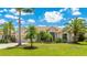 Beautiful one-story home featuring lush landscaping, mature palm trees, and a well-manicured lawn at 12822 Kite Dr, Bradenton, FL 34212