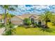 Inviting single-story home featuring a lush lawn, beautiful landscaping, and a two-car garage at 12822 Kite Dr, Bradenton, FL 34212