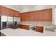 Modern kitchen featuring stainless steel appliances, granite countertops, and ample storage space at 12822 Kite Dr, Bradenton, FL 34212
