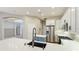 Bright kitchen features an eat-in island with quartz countertops and stainless steel appliances at 12822 Kite Dr, Bradenton, FL 34212