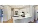An open kitchen with stainless steel appliances, white cabinets, and a center island at 12822 Kite Dr, Bradenton, FL 34212
