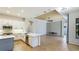 Modern kitchen featuring stainless steel appliances, an island, and white cabinetry with ample counter space at 12822 Kite Dr, Bradenton, FL 34212
