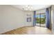 Modern living room with hardwood floors, recessed lighting, and a backyard view through sliding glass doors at 12822 Kite Dr, Bradenton, FL 34212