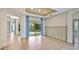 Open-concept living room with tile flooring, neutral walls, and large sliding doors overlooking the pool at 12822 Kite Dr, Bradenton, FL 34212