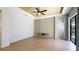 Open living room with ceiling fan and access to pool area through sliding glass doors at 12822 Kite Dr, Bradenton, FL 34212