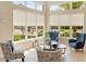 Comfortable lounge area featuring arm chairs, side tables, and a view of well-maintained landscaping at 12822 Kite Dr, Bradenton, FL 34212