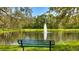 Beautiful pond with a fountain, green surroundings and bench for peaceful contemplation at 12822 Kite Dr, Bradenton, FL 34212