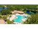 Aerial view of the community pool, clubhouse, surrounding lakes, and lush landscaping for an inviting retreat at 12822 Kite Dr, Bradenton, FL 34212