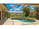 Stunning screened-in pool area with lush landscaping and outdoor kitchen, perfect for relaxation and entertainment at 12822 Kite Dr, Bradenton, FL 34212