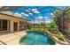 Beautiful screened-in pool area with outdoor kitchen, offering a private and serene backyard retreat at 12822 Kite Dr, Bradenton, FL 34212