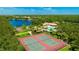 Aerial view of community amenities: tennis courts, basketball court, pool, playground, and lake at 12822 Kite Dr, Bradenton, FL 34212