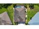 Aerial view showing the home's backyard with a screened pool, hot tub and mature trees at 12841 Balsam Ter, Bradenton, FL 34212