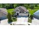 Beautifully landscaped home with mature trees, a three-car garage and a lush green lawn at 12841 Balsam Ter, Bradenton, FL 34212