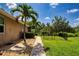 Beautiful backyard with a stone paver pathway, green lawn, and mature trees providing shade and privacy at 12841 Balsam Ter, Bradenton, FL 34212