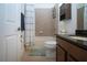 Cozy bathroom with tiled walls, dark wood cabinets, tub, toilet, and decorative storage solutions at 12841 Balsam Ter, Bradenton, FL 34212