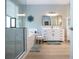 This bathroom features a glass shower and modern vanity with a small, cushioned stool at 12841 Balsam Ter, Bradenton, FL 34212