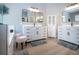 Bathroom with dual vanities, modern mirrors, and sleek storage cabinet at 12841 Balsam Ter, Bradenton, FL 34212