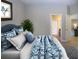 Serene bedroom with a plush bed, stylish bedding, and an open doorway leading to other areas at 12841 Balsam Ter, Bradenton, FL 34212
