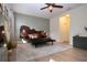 Light-filled bedroom features a hardwood floor, ceiling fan, and decorative mirror at 12841 Balsam Ter, Bradenton, FL 34212