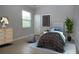 Comfortable bedroom with neutral walls, stylish decor, and plenty of natural light from the window at 12841 Balsam Ter, Bradenton, FL 34212