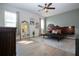 Light-filled bedroom features a hardwood floor, ceiling fan, and decorative mirror at 12841 Balsam Ter, Bradenton, FL 34212