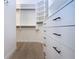 Walk-in closet with custom shelves and drawers offers ample storage at 12841 Balsam Ter, Bradenton, FL 34212