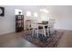 Bright dining room with white table and chairs illuminated by modern pendant lighting at 12841 Balsam Ter, Bradenton, FL 34212