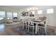 Cozy dining area featuring a white table with seating for six and elegant decor at 12841 Balsam Ter, Bradenton, FL 34212