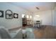Open-concept dining area with a table, chairs and modern lighting fixtures next to a sitting area at 12841 Balsam Ter, Bradenton, FL 34212