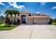 Charming home with a three-car garage, meticulously landscaped yard and a welcoming front entrance at 12841 Balsam Ter, Bradenton, FL 34212