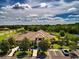 Beautiful clubhouse exterior showcasing lush landscaping, paved parking, and a well-maintained facade under a partly cloudy sky at 12841 Balsam Ter, Bradenton, FL 34212