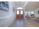 Bright foyer with double entry doors and tile flooring leading to an open living space with hardwood flooring at 12841 Balsam Ter, Bradenton, FL 34212