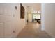 Hallway leading to living area showcasing neutral tile flooring and interior design at 12841 Balsam Ter, Bradenton, FL 34212