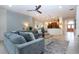 Open-concept living room with sectional sofa flowing into dining and kitchen areas at 12841 Balsam Ter, Bradenton, FL 34212