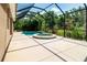 Enjoy the outdoor life with this screened-in pool and spa surrounded by lush tropical landscaping at 12841 Balsam Ter, Bradenton, FL 34212