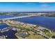 Stunning aerial view of waterfront homes, a marina, tennis courts, and a community pool under a clear blue sky at 1294 Riverscape St # D, Bradenton, FL 34208