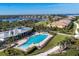 Aerial view of a community pool with a view of waterfront homes and marina at 1294 Riverscape St # D, Bradenton, FL 34208