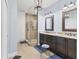 Well-lit bathroom featuring a glass shower, double vanity, and decorative mirrors at 1294 Riverscape St # D, Bradenton, FL 34208