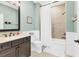 Bathroom with a combined shower and tub, modern vanity, and light green walls at 1294 Riverscape St # D, Bradenton, FL 34208