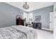 Comfortable bedroom with a writing desk, chair, chest of drawers, plush carpet, and stylish light fixture at 1294 Riverscape St # D, Bradenton, FL 34208