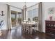 Dining area with windows, wood floors, and access to a screened in patio at 1294 Riverscape St # D, Bradenton, FL 34208